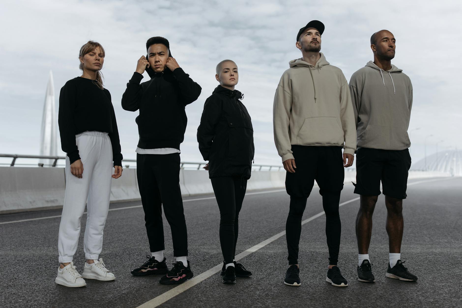 stylish people wearing activewear standing on the road